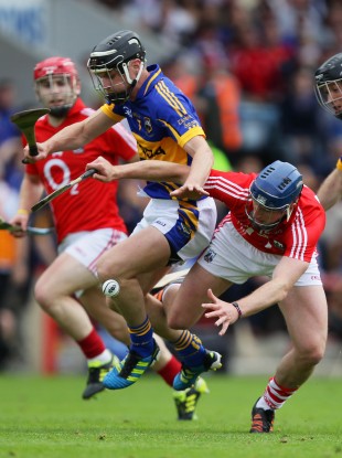 Cork's Patrick Horgan and Paul Curran of Tipperary battle for possession.