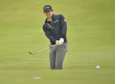 Rory McIlroy chips in during practice.