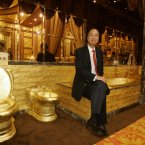 Lam Sai Wing sits in the golden bathroom at the Swisshorn Gold Palace in Hong Kong. (AP Photo/Kin Cheung)