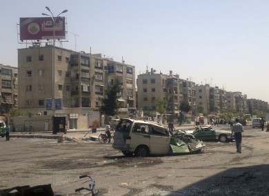 This citizen journalist image shows a destroyed vehicles after fighting between rebels and Syrian troops in the Yarmouk camp for Palestinian refugees in south Damascus