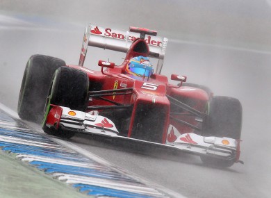 Spain's Fernando Alonso steers his car through the rain to win the qualifying of the German F1 Grand Prix in Hockenheim.