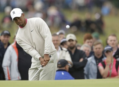 Tiger Woods chip towards the pin on the fifth hole.