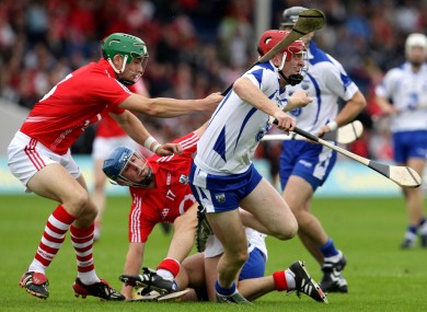 Cork's Eoin Cadogan and Waterford's John Mullane clashing in the 2010 Munster senior hurling final replay.