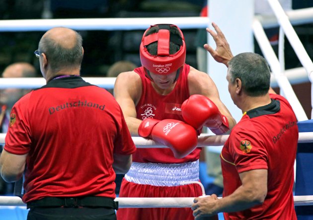 A dejected Darren O'Neill is consoled by his German opponent's corner men 2/8/2012