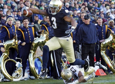 Notre Dame wide receiver Michael Floyd (3) scores a touchdown after getting past Navy cornerback Eric Graham in 2011.
