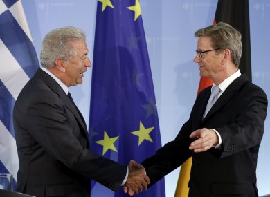 Greek foreign minister Dimitris Avramopulos (left) shakes hands with his German counterpart Guido Westerwelle after a meeting in Berlin today.