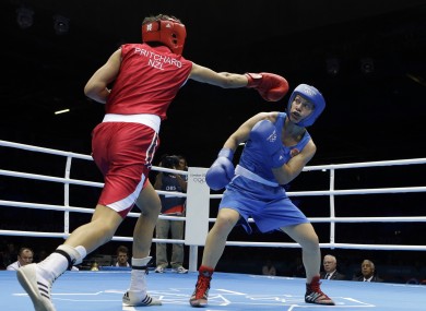 Ochigava, blue, dodges a punch from New Zealand's Alexis Pritchard in the women's lightweight quarter-final.