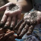 A Pakistani girl gets her hands painted with henna in preparation for the upcoming Eid al-Fitr festival, in Karachi, Pakistan, Saturday. Eid al-Fitr marks the end of the holy month of Ramadan. (AP Photo/Fareed Khan)