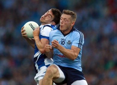 Laois player Colm Begley is challenged by Dublin's Paul Flynn.