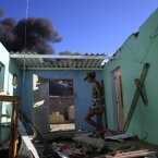 Magda Caseres walks among debris of her home shattered by the explosion. (AP Photo/Ariana Cubillos/PA)