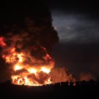 A large fire rises over the Amuay refinery on Saturday. (AP Photo/Ariana Cubillos/PA)