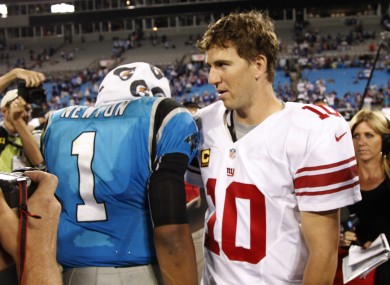 Carolina Panthers' Cam Newton (1) meets New York Giants' Eli Manning (10) after the game.