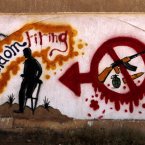 Graffiti on one of the city walls calls on people to stop random firing of weapons, in Benghazi, Libya. (AP Photo/Mohammad Hannon)