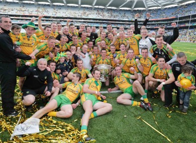 The Donegal team and management celebrate with the Sam Maguire.