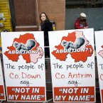 A woman walks past pro-life posters outside the Marie Stopes clinic on Great Victoria Street in Belfast. Photo: Laura Hutton/Photocall Ireland