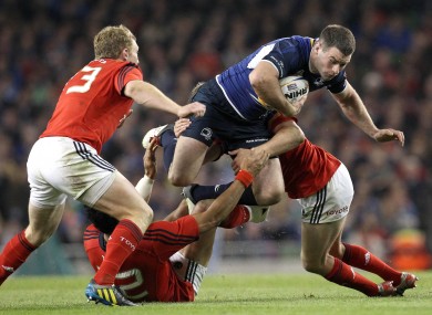 Munster's Casey Laulala and Ronan O'Gara with Fergus McFadden of Leinster.