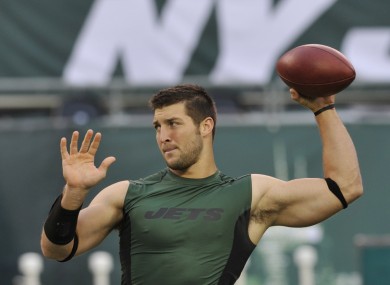 Tim Tebow warms up on Sunday.