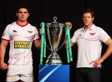 Scarlets Director of Rugby, Simon Easterby (right) and captain Rob McCusker pose with the Heineken Cup yesterday.