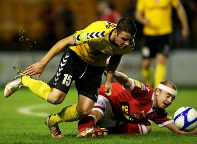 Shelbourne's Paul Byrne slides in on Stephen McLaughlin.