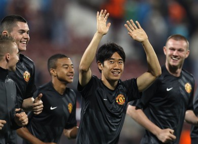 Manchester United's Shinji Kagawa, second from right, salutes supporters that were chanting his name in Cluj.