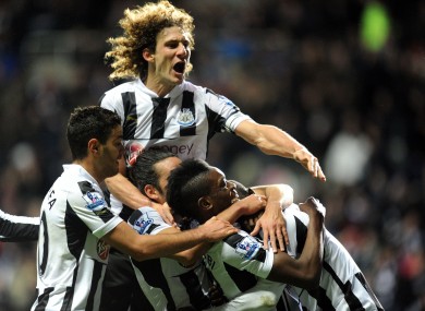 Newcastle United players mob Papiss Cisse after his late goal.