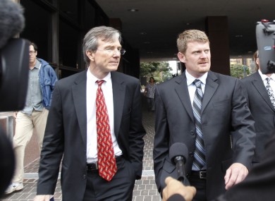 Floyd Landis, right, and his attorney, Leo Cunningham, leaving federal court in San Diego.