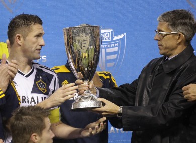 Los Angeles Galaxy captain Robbie Keane, left, is given the MLS Western Conference championship cup.
