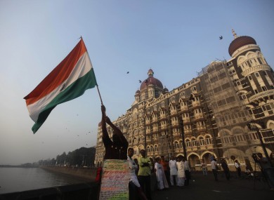 A man waves an Indian flag outside the Taj Mahal hotel, one of the sites of the Mumbai terror attacks