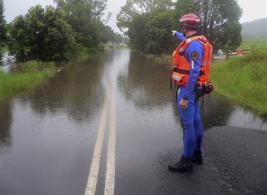 A police officer at Bruxner Highway, which is covered with floodwaters caused by torrential rains in northern New South Wales.