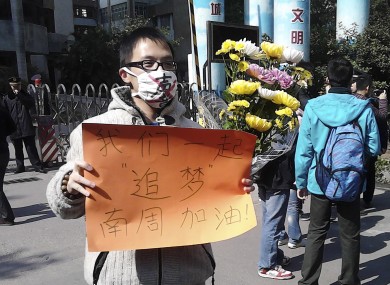 In this photo taken and provided by activist Wu Wei, a man wearing a mask with words