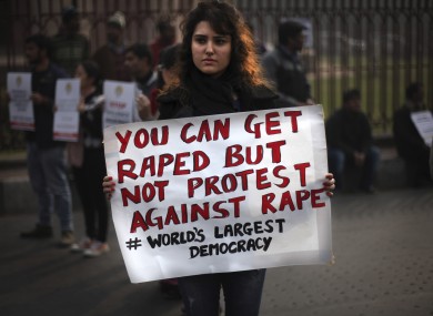 An Indian protester holds a placard during a protest against the gang rape of a young woman on a bus in New Delhi in December.