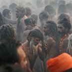 Naked Hindu holy men or a Naga Sadhus dry their hairs after a dip at Sangam. (AP Photo /Manish Swarup)