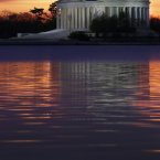 The sun rises behind the Jefferson Memorial in Washington on a cloudy day in Washington. A winter weather advisory has been issued for the area with light snow excepted later in the evening. (AP Photo/J. David Ake)