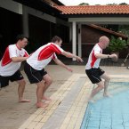 Mullane won five Allstar awards during his career. Here in 2006, Waterford's Paul Flynn and Eoin Kelly give him a helping hand into the pool in Singapore.