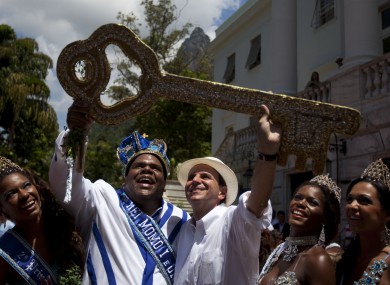 King Momo and Rio de Janeiro's Mayor Eduardo Paes hold up the key of the city to open Carnival.