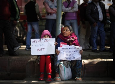 Indian woman and child at protest over India's treatment of violence against women.