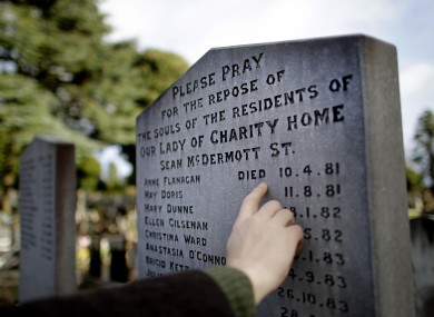 A man looks at a burial plot for victims of the Magdalene Laundries in Glasnevin Cemetery, Dublin.