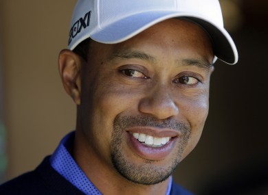 Tiger Woods smiles during a news conference before playing a practice round for the Match Play Championship yesterday.