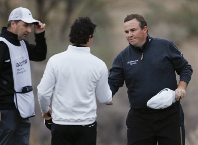 Lowry and McIlroy shake hands.