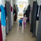 More than 60% of refugees who have crossed the border into Jordan are women and children. This building in the Cyber City camp houses up to 5 people in each 8x8 foot room, many of the rooms have only a blanket to serve as a door and to keep out the cold.  
Photo: Kenneth O' Halloran, Irish Red Cross