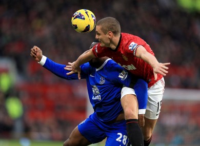 Everton's Victor Anichebe (left) and Manchester United's Nemanja Vidic (right) battle for the ball.