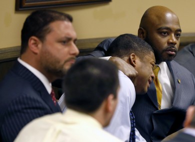 Ma'lik Richmond, second from right, is held by his lawyer as the judge finds him guilty in court on Sunday