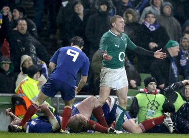 Keith Earls protests to Steve Walsh after Vincent Debaty's tackle.