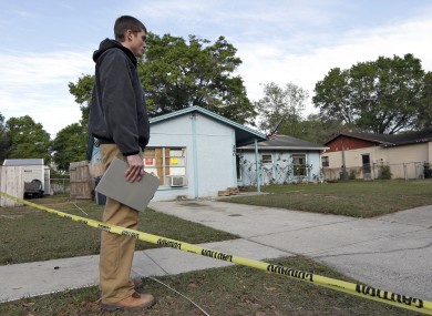 An engineer stands in front of a home where sinkhole opened up