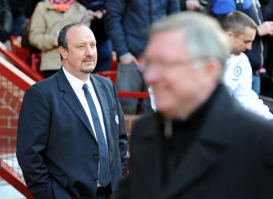 Alex Ferguson strolls by Rafa Benitez before kick-off.