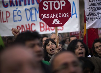 Protesters hold banners against evictions as they march along a street during a demonstration in Barcelona, Spain.